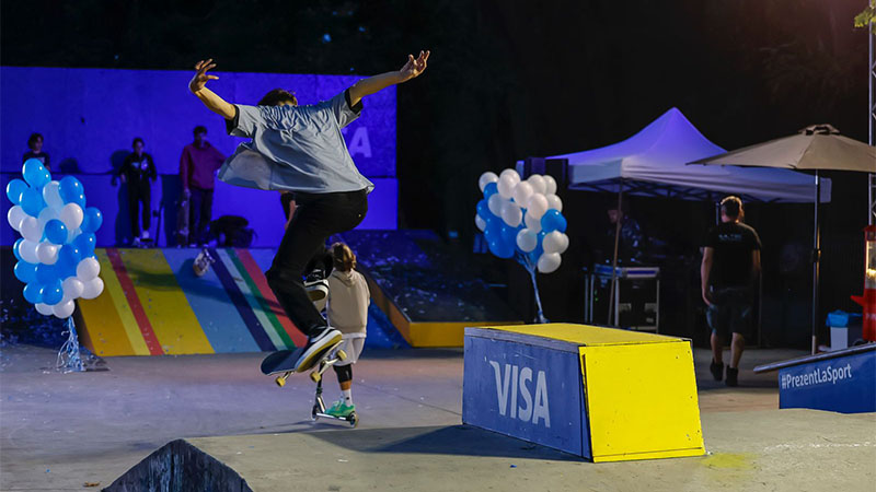 man on skateboard jumping in skatepark